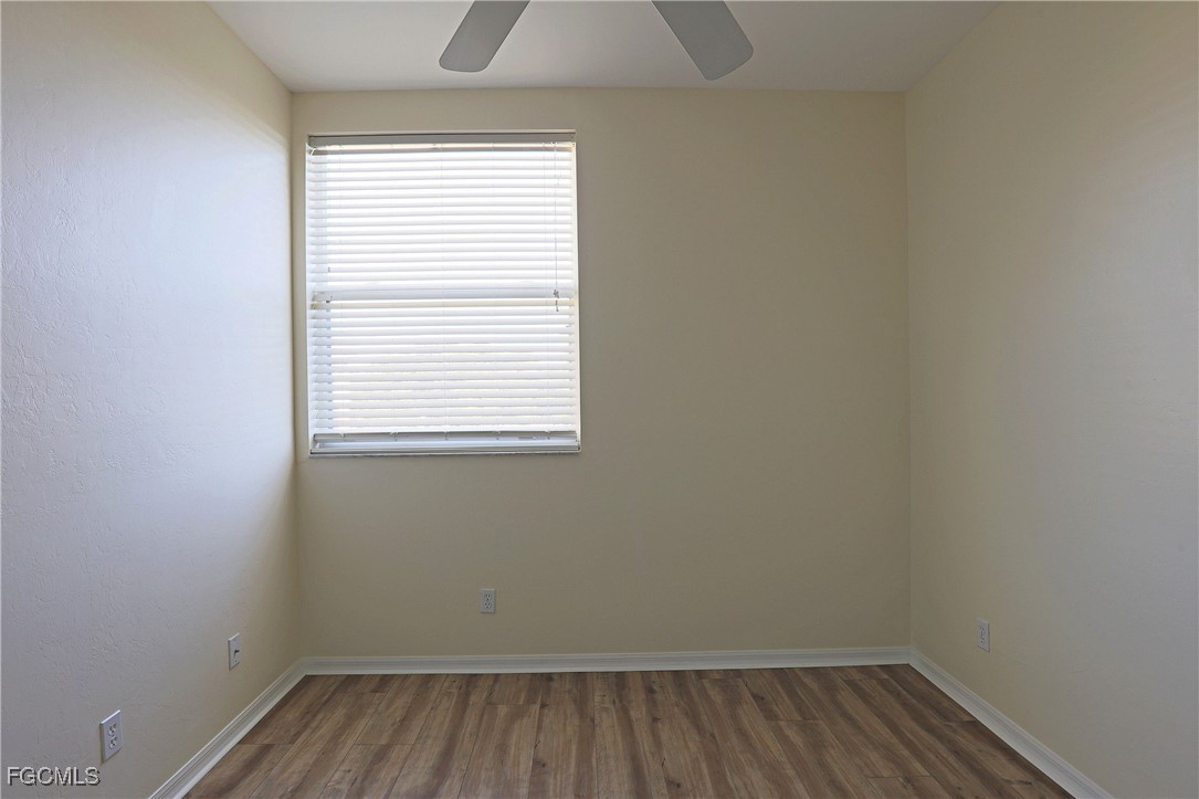 4199 Bellasol Circle, Unit 622 Fort Myers, FL 33916 - Photo 11 of 27 a small space with wooden floor and a window