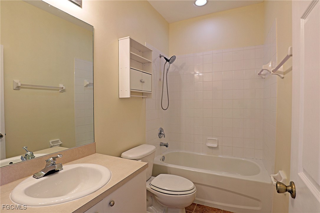 4199 Bellasol Circle, Unit 622 Fort Myers, FL 33916 - Photo 13 of 27 a bathroom with a sink toilet and shower