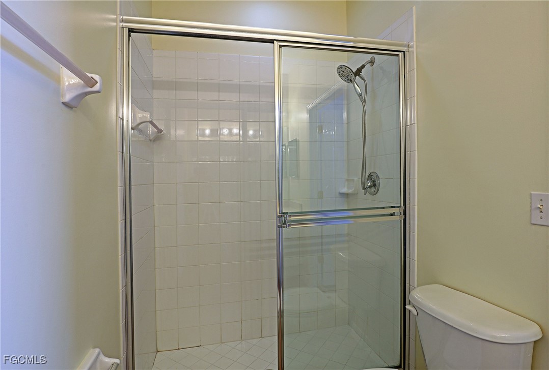 4199 Bellasol Circle, Unit 622 Fort Myers, FL 33916 - Photo 14 of 27 a bathroom with a glass shower door