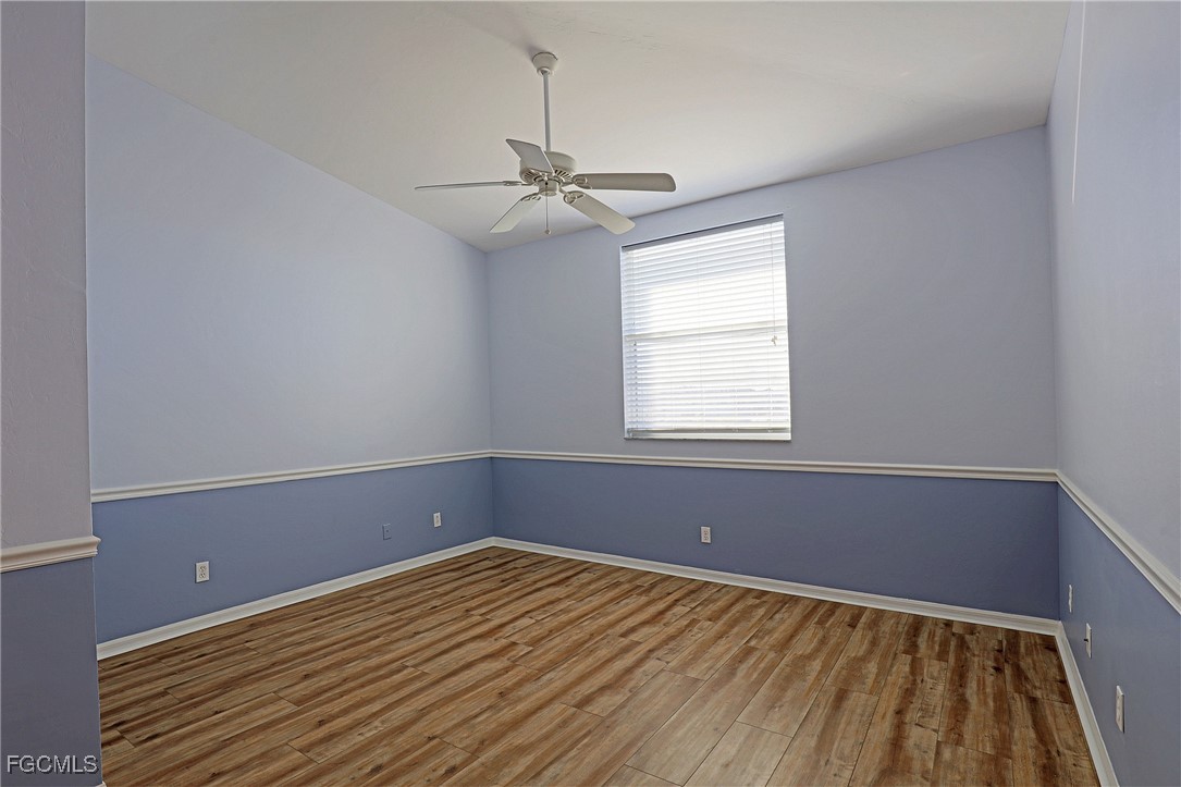 4199 Bellasol Circle, Unit 622 Fort Myers, FL 33916 - Photo 18 of 27 wooden floor in an empty room with a window