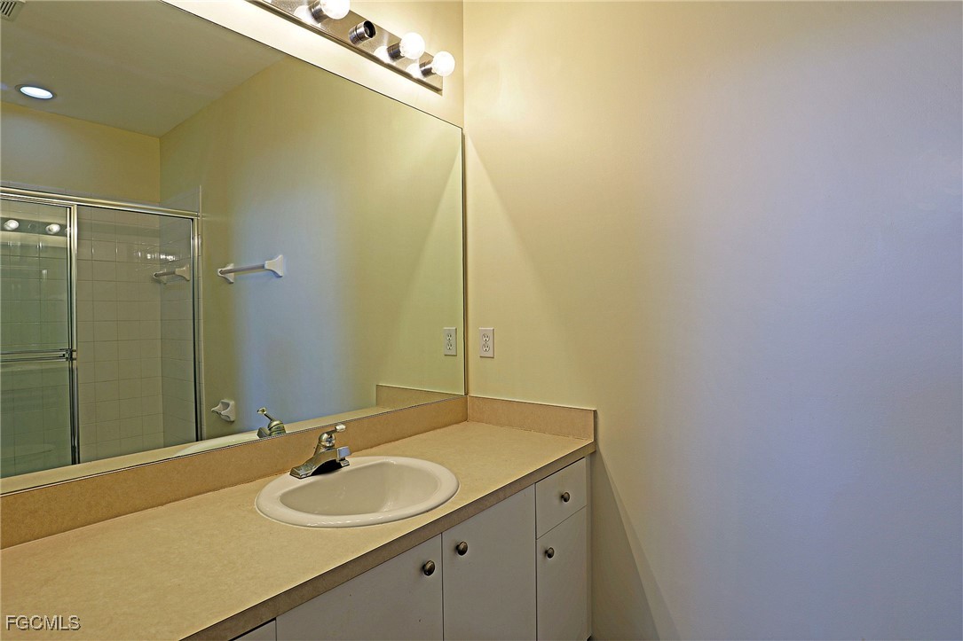 4199 Bellasol Circle, Unit 622 Fort Myers, FL 33916 - Photo 19 of 27 a bathroom with a sink and a mirror