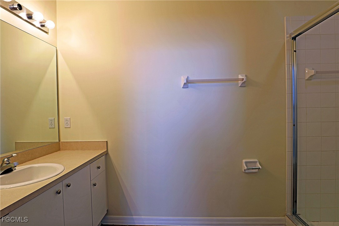 4199 Bellasol Circle, Unit 622 Fort Myers, FL 33916 - Photo 21 of 27 a bathroom with a sink and mirror