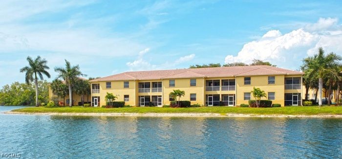 4199 Bellasol Circle, Unit 622 Fort Myers, FL 33916 - Photo 3 of 27 a front view of a house with swimming pool and yard
