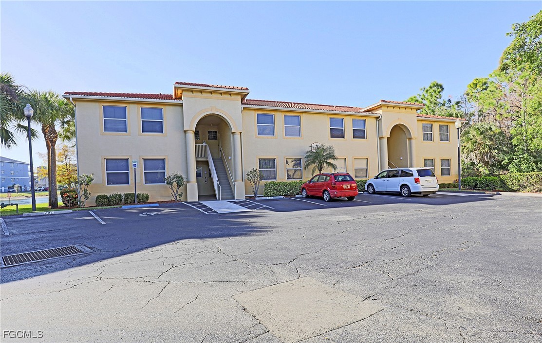 4199 Bellasol Circle, Unit 622 Fort Myers, FL 33916 - Photo 5 of 27 a group of cars parked in front of a building