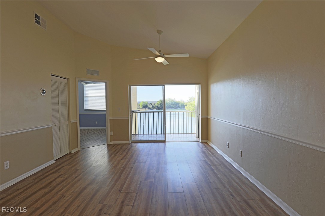 4199 Bellasol Circle, Unit 622 Fort Myers, FL 33916 - Photo 6 of 27 wooden floor in an empty room with a window