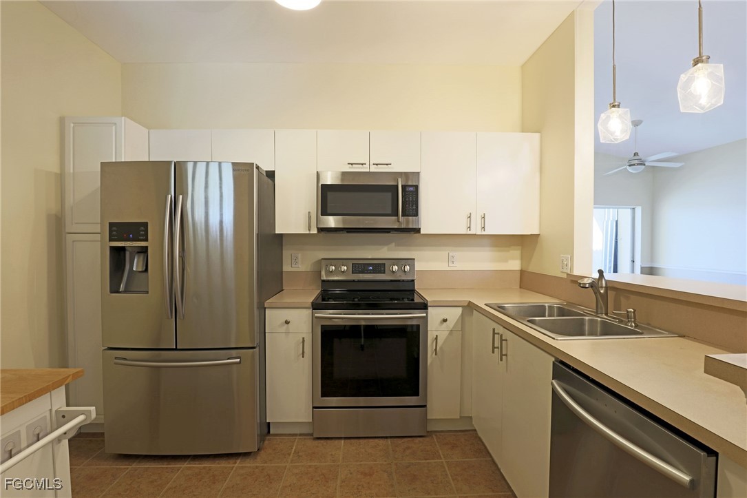 4199 Bellasol Circle, Unit 622 Fort Myers, FL 33916 - Photo 8 of 27 a kitchen with a sink stove and refrigerator