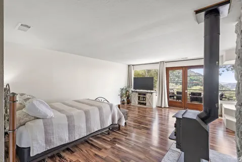 a spacious bedroom with a bed couch and a large window