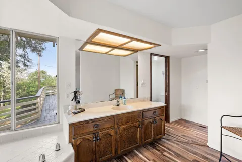 a bathroom with a double vanity sink and a mirror