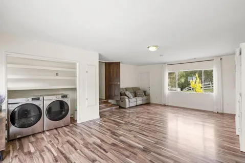 a view of a livingroom with furniture and wooden floor