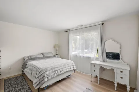 a bedroom with a bed and a table in it