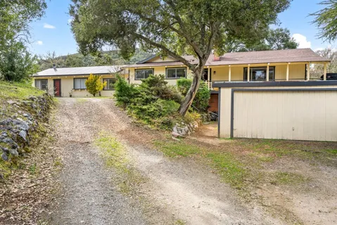 a front view of a house with a yard and a garage