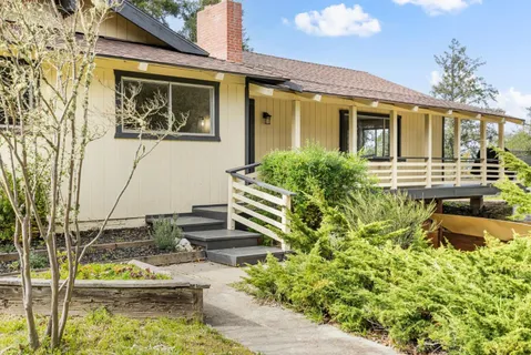 a front view of a house with garden