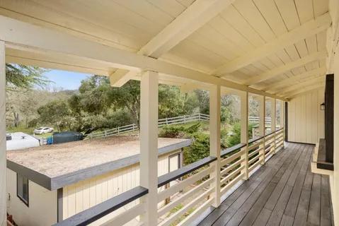a view of a room with wooden floor and windows