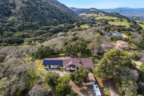 an aerial view of a house with a mountain view