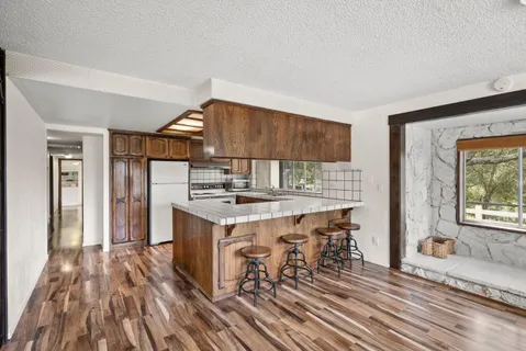 a kitchen that has a sink and a stove in it