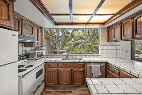 a kitchen with stainless steel appliances granite countertop a stove and a sink