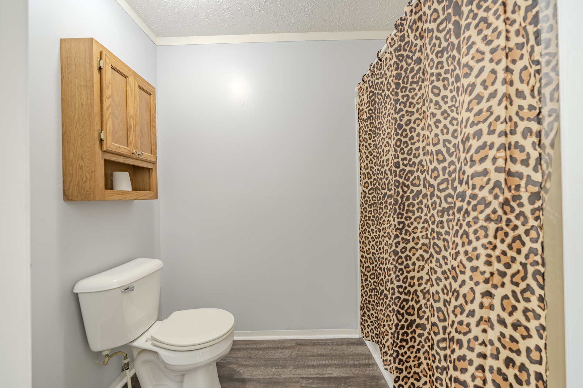 1125 Clifft Road Bolivar, TN 38008 - Photo 39 of 78 a bathroom with a toilet and a shower curtain