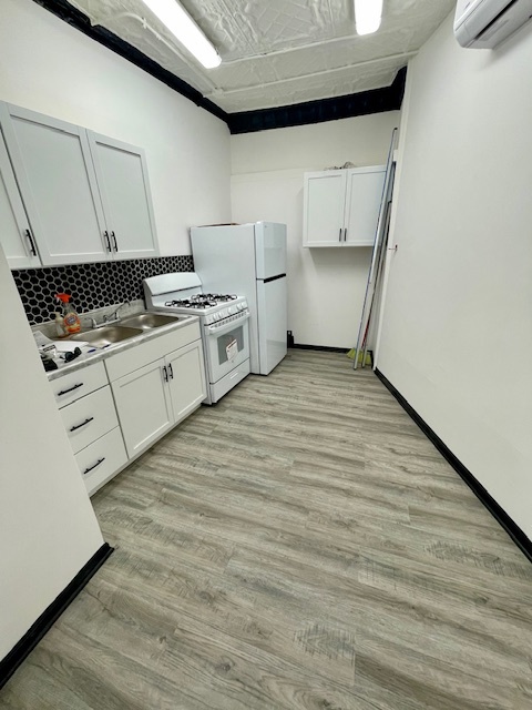 302 West Naperville Road Westmont, IL 60559 - Photo 14 of 15 a kitchen with a stove and white cabinets