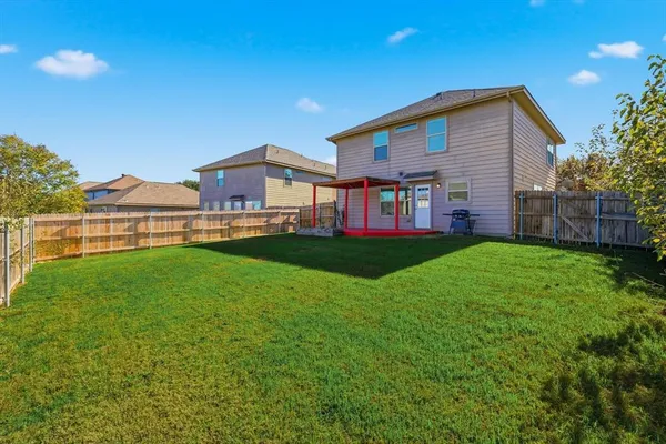 a view of a house with a yard and sitting area
