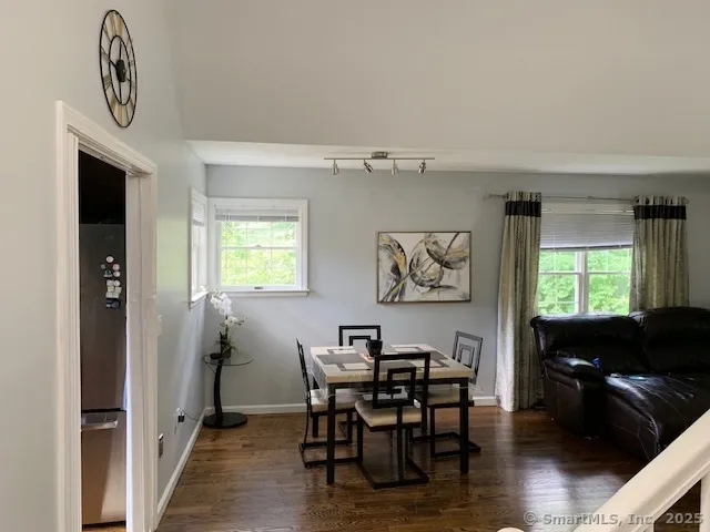 a view of a dining room with furniture and window
