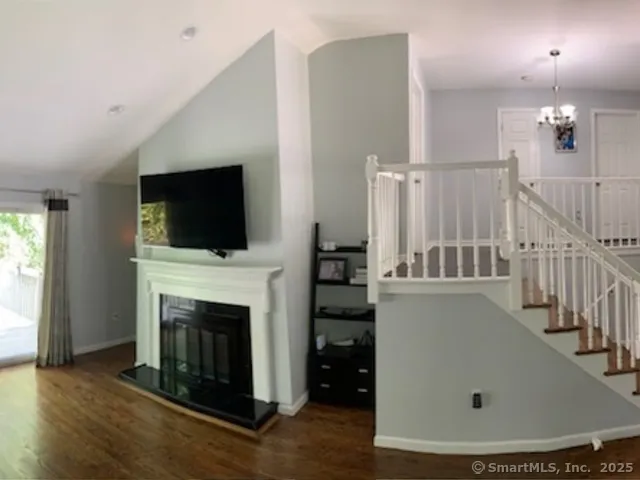 a living room with a fireplace and a flat screen tv