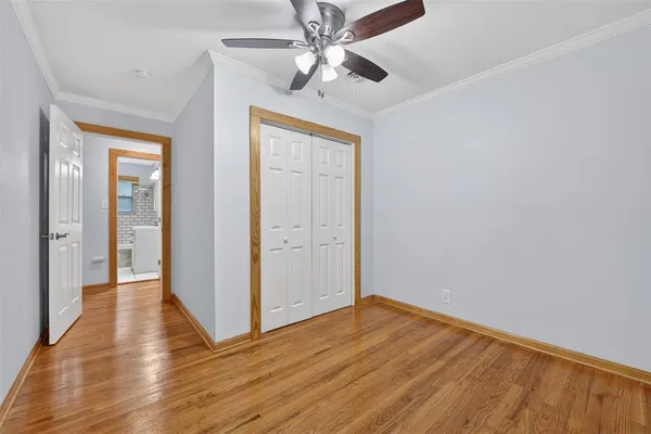 a view of empty room with wooden floor