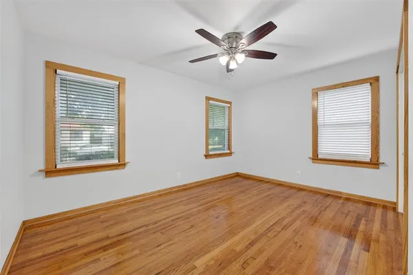 a view of an empty room with chandelier and a window