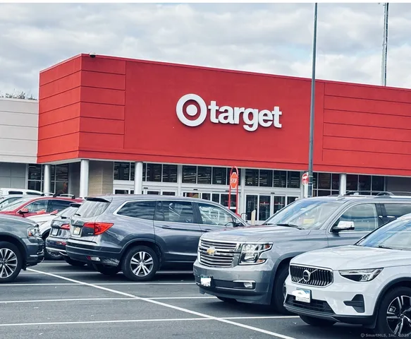 a view of a cars park in front of a building