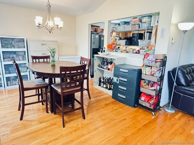 a view of a dining room with furniture kitchen and wooden floor