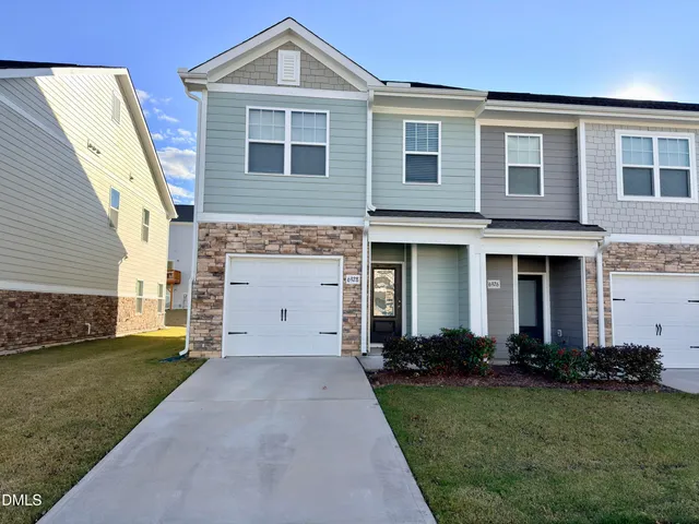 a front view of a house with a yard and garage