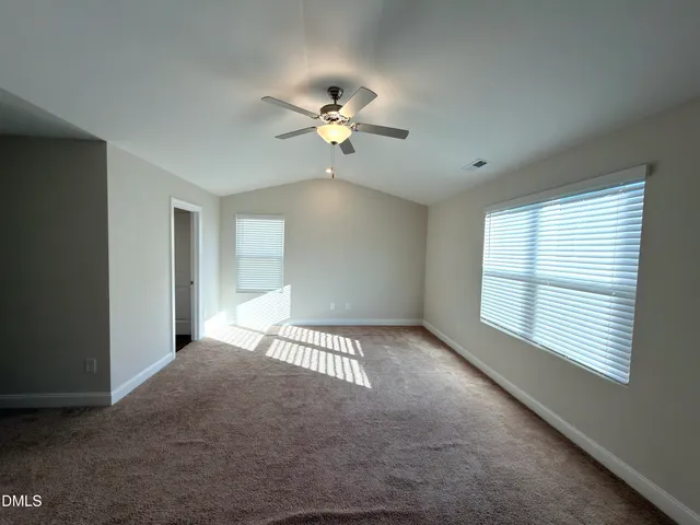 a view of a room with a ceiling fan and a window