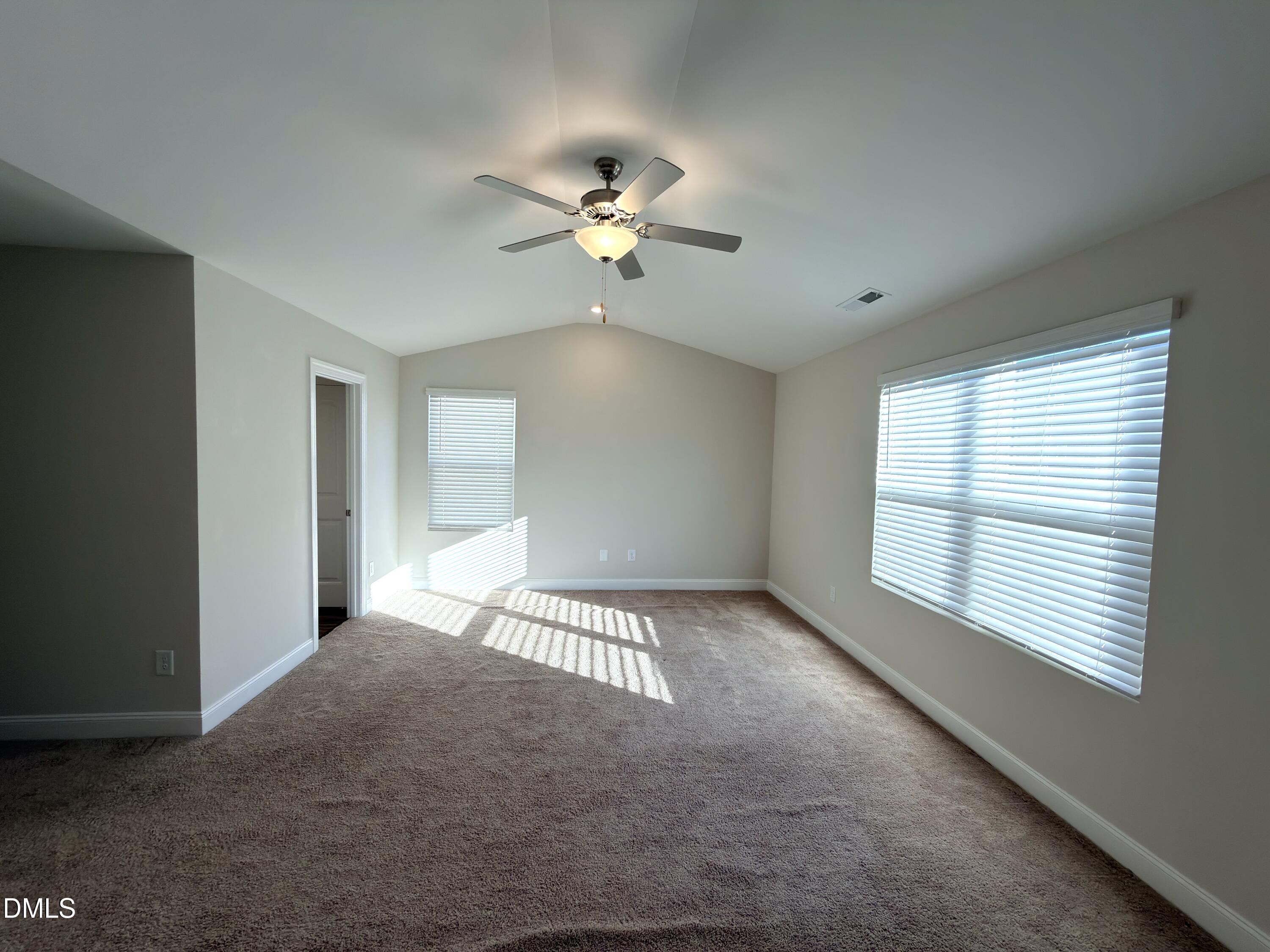 6928 Outfall Point Lane Raleigh, NC 27616 - Photo 13 of 33 a view of a room with a ceiling fan and a window