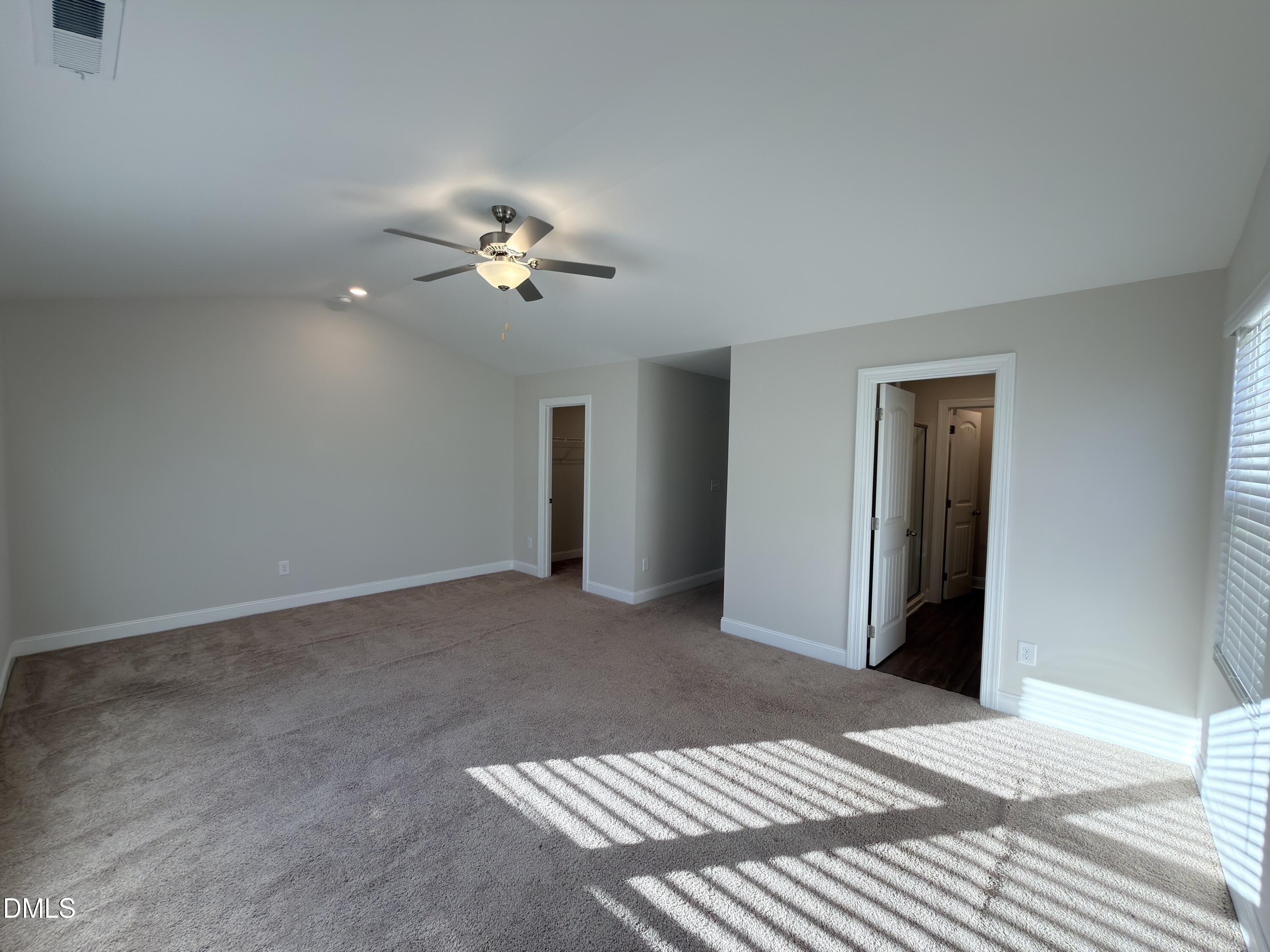 6928 Outfall Point Lane Raleigh, NC 27616 - Photo 14 of 33 a view of a bedroom with a ceiling fan and a chandelier fan