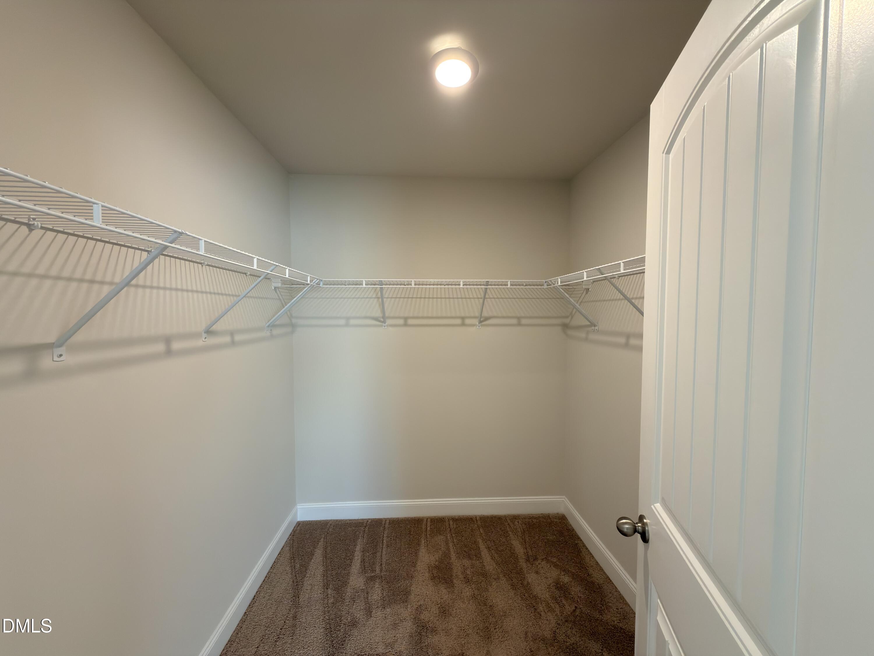 6928 Outfall Point Lane Raleigh, NC 27616 - Photo 18 of 33 a view of a room with racks on the wall