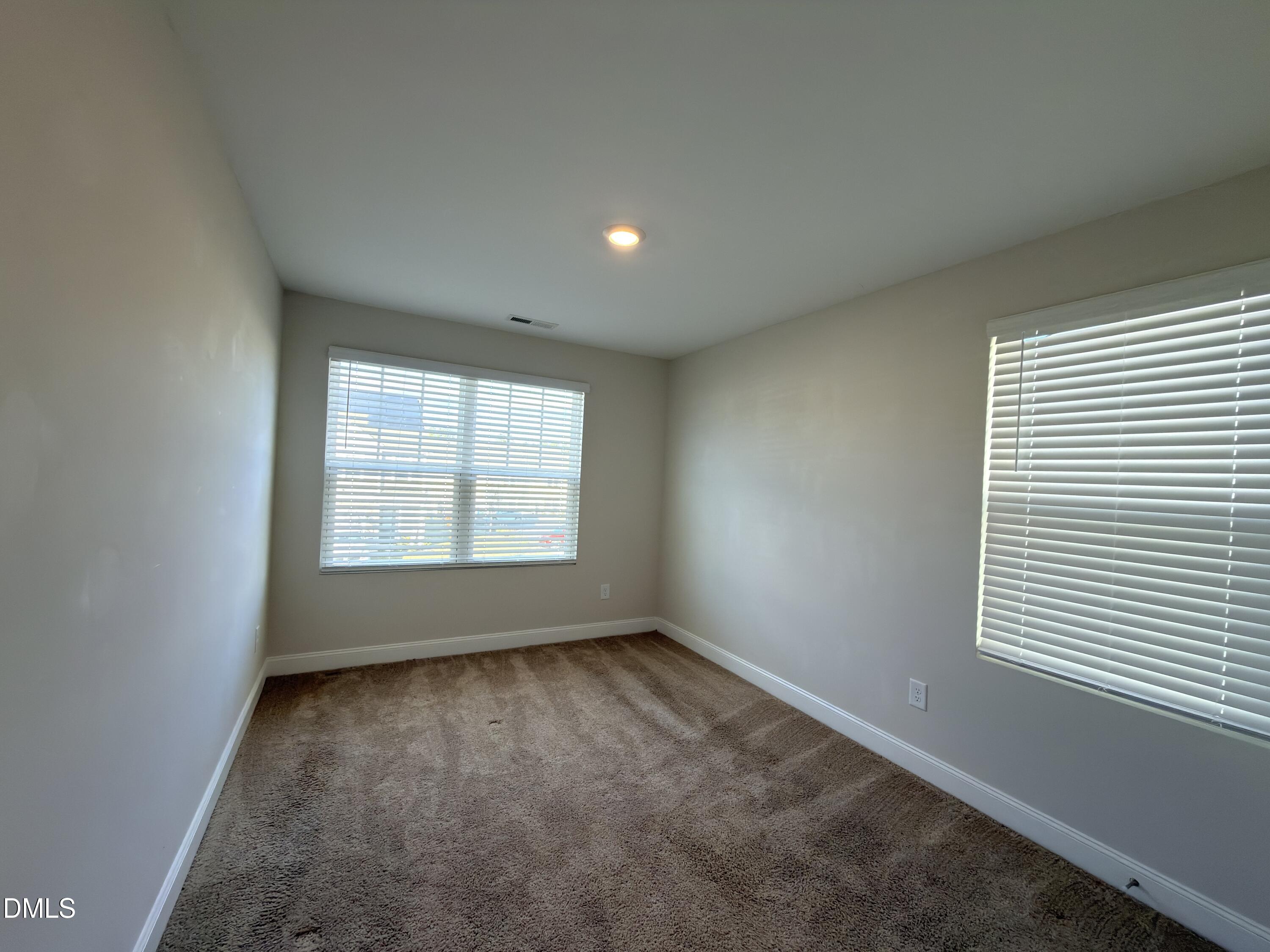 6928 Outfall Point Lane Raleigh, NC 27616 - Photo 19 of 33 an empty room with a window