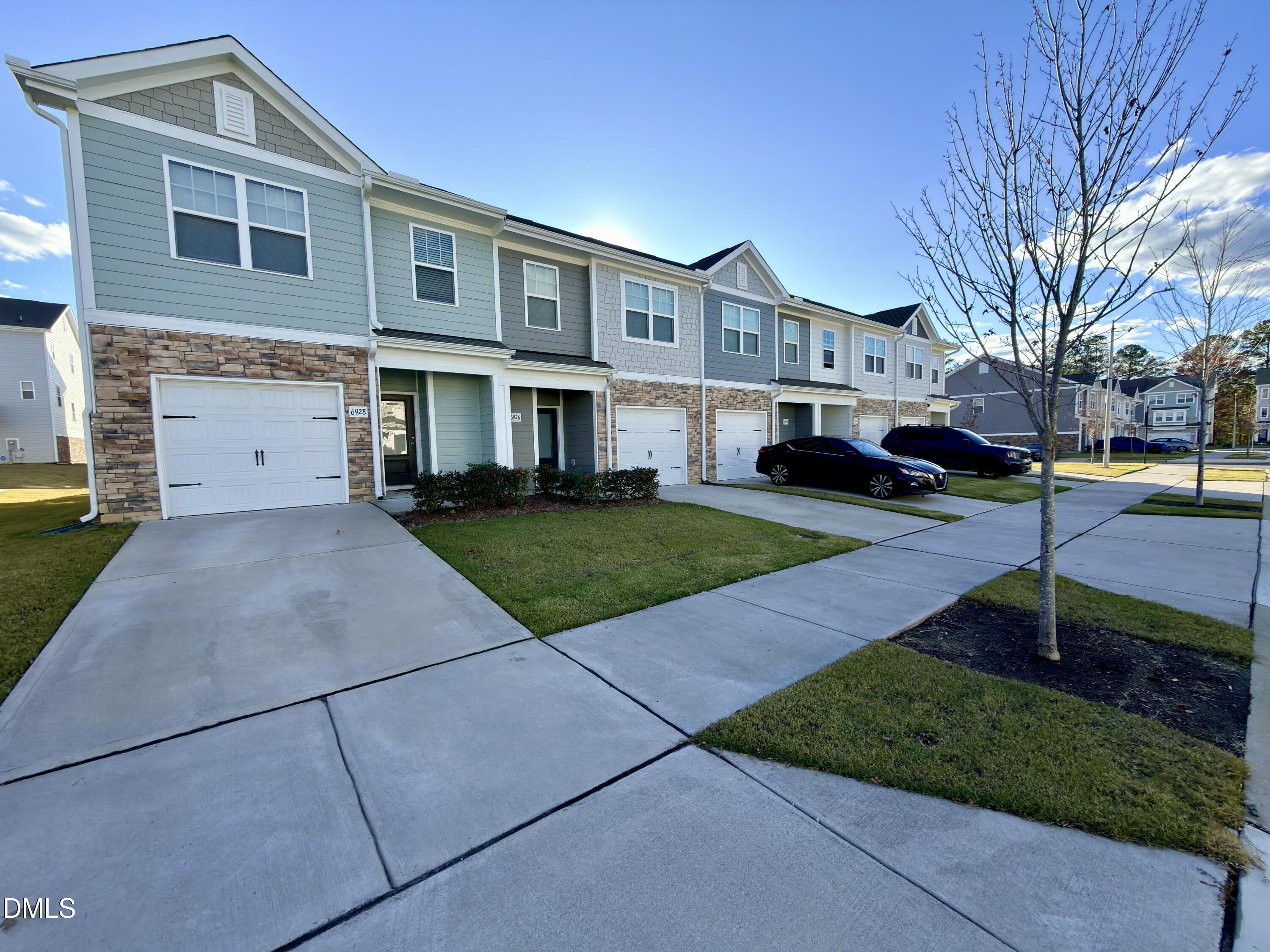 6928 Outfall Point Lane Raleigh, NC 27616 - Photo 3 of 33 a front view of a house with garden
