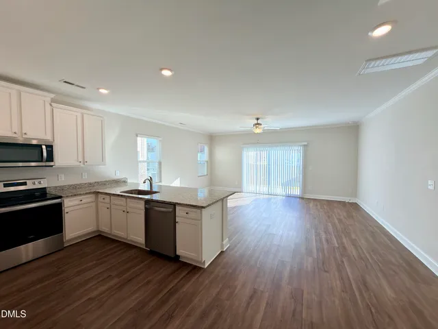 a kitchen with wooden floors and appliances