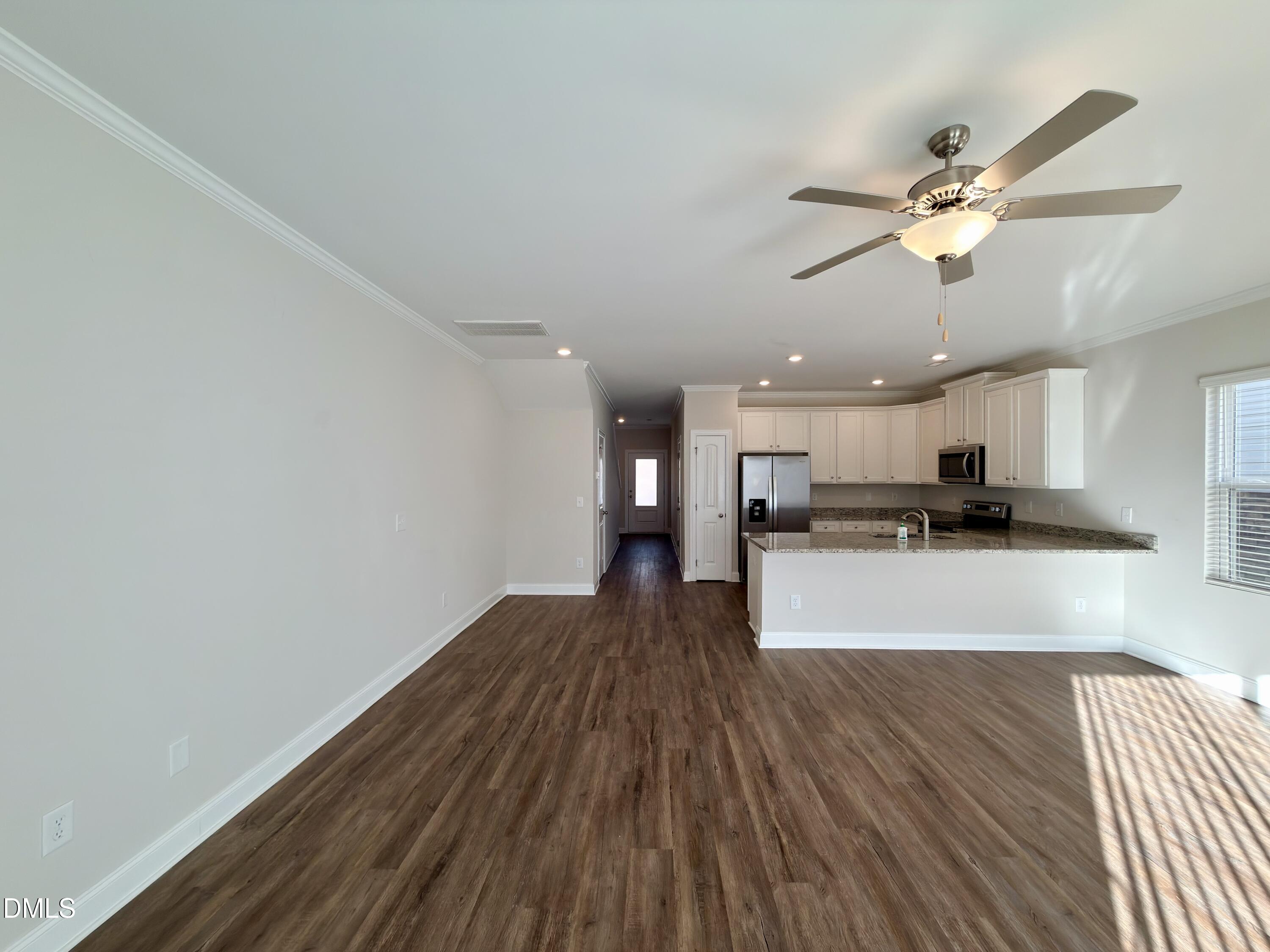 6928 Outfall Point Lane Raleigh, NC 27616 - Photo 8 of 33 a view of a kitchen with a sink and a ceiling fan
