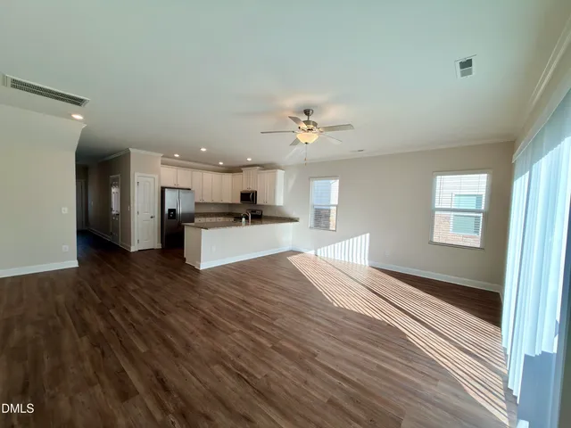 a view of a kitchen with a sink a refrigerator and window