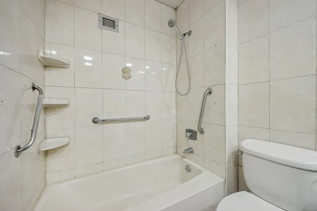 a bathroom with a shower and a toilet