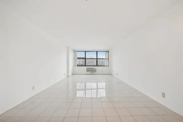 an empty room with white walls and tiles