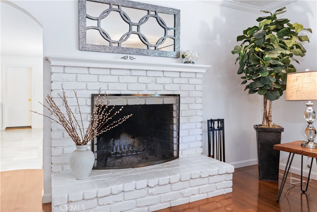 7695 Del Rio Road Atascadero, CA 93422 - Photo 18 of 75 a living room with a fireplace a potted plant and a wooden floor