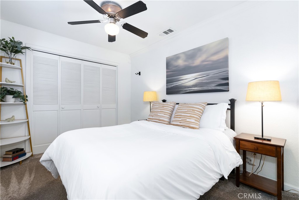 7695 Del Rio Road Atascadero, CA 93422 - Photo 36 of 75 a bedroom with a bed and a lamp on the dresser