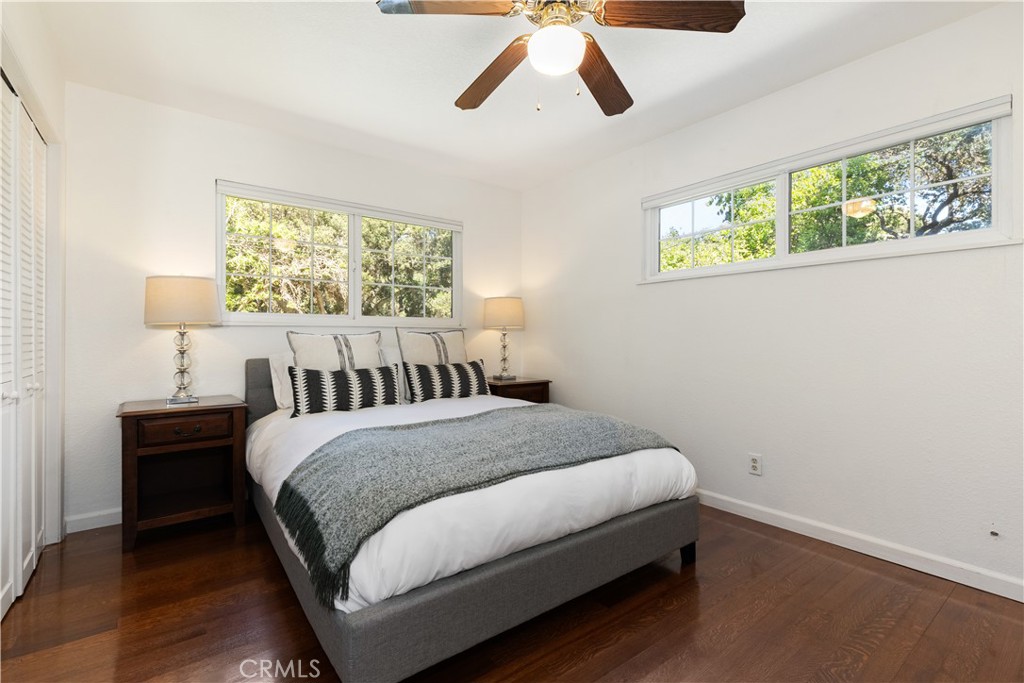 7695 Del Rio Road Atascadero, CA 93422 - Photo 40 of 75 a bedroom with a bed and wooden floor