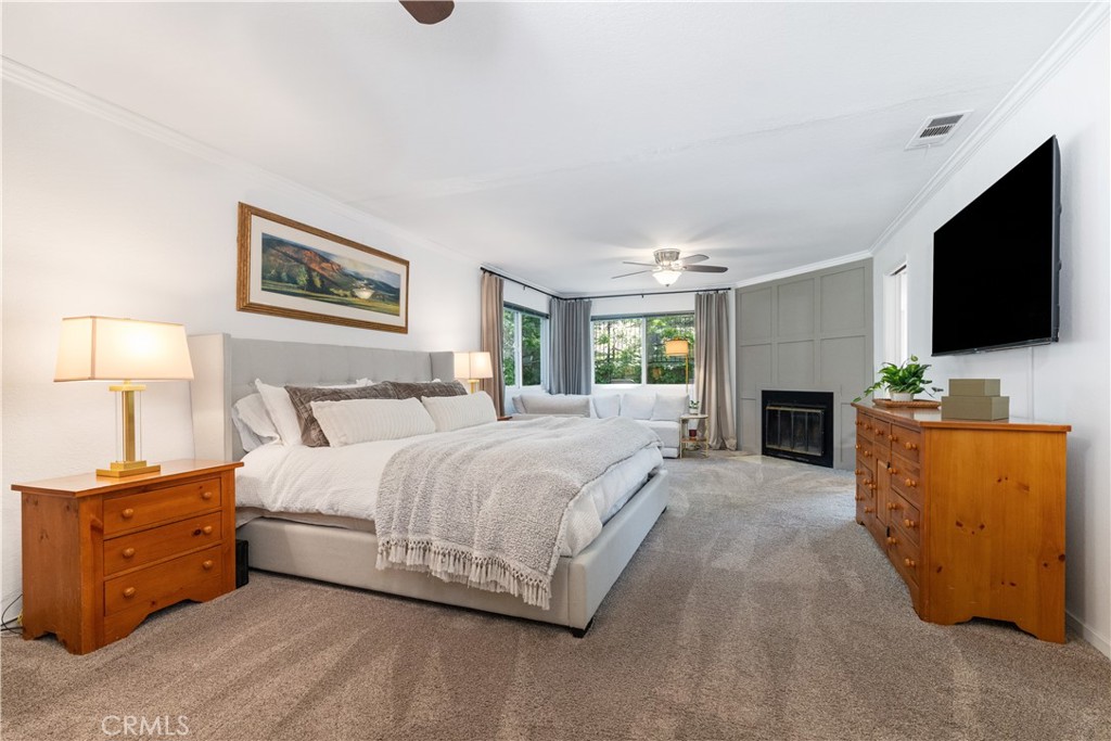 7695 Del Rio Road Atascadero, CA 93422 - Photo 42 of 75 a spacious bedroom with a bed and a flat screen tv