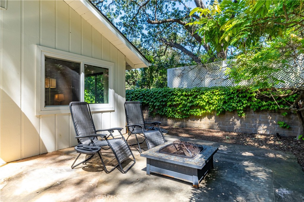 7695 Del Rio Road Atascadero, CA 93422 - Photo 55 of 75 a view of a patio with chair and tables back yard of the house