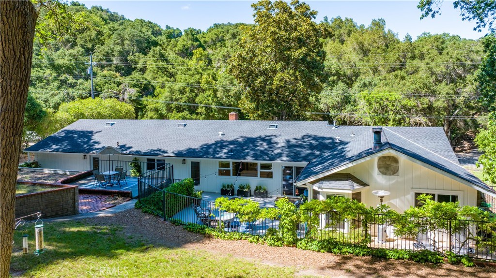 7695 Del Rio Road Atascadero, CA 93422 - Photo 60 of 75 a front view of a house with a yard and potted plants