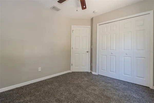an empty room with windows and closet