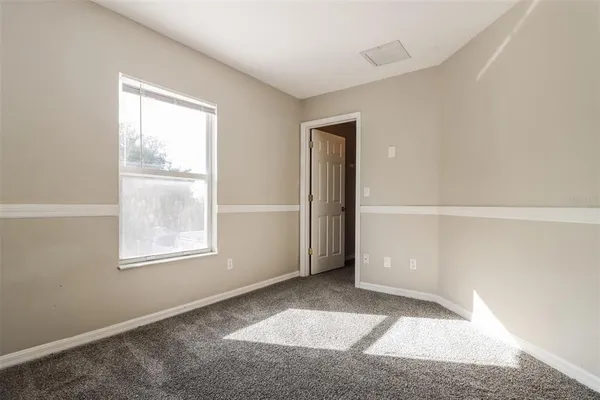 an empty room with ceiling fan