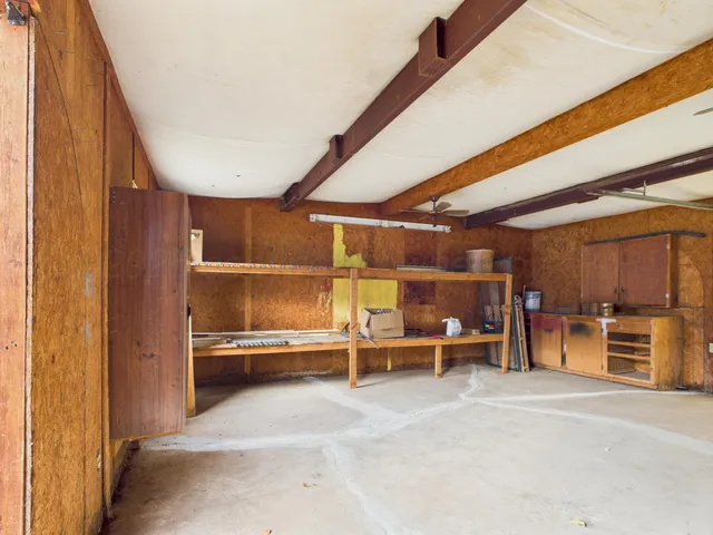 a view of a room with wooden shelves and racks